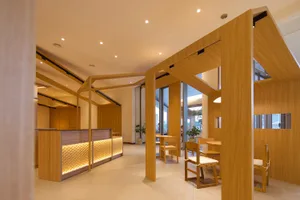 Modern office space featuring wooden panels and furniture, with a contemporary design.