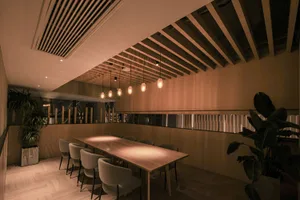 Industrial-style restaurant interior with wooden tables and concrete accents