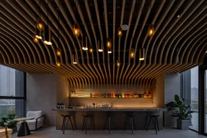 Modern bar interior featuring wooden ceiling panels and stools, illuminated by warm pendant lights.