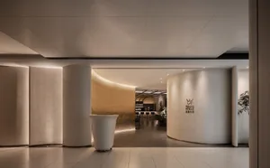 Modern restaurant entrance with concrete columns and ambient lighting