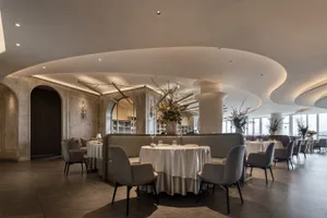 A modern elegant dining room with soft lighting and contemporary furniture.