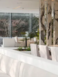 Contemporary restaurant lounge with marble finishes and green plants