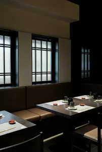Modern restaurant interior featuring wooden tables and seating arrangements.