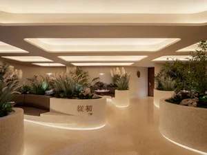 A contemporary restaurant interior featuring modern concrete planters.