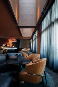 Modern bar lounge interior with velvet furniture and marble accents