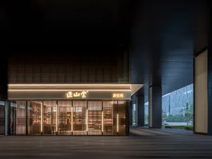A modern retail storefront with a metallic frame and glass panels.
