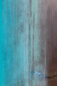 Vertical striped wood panel with a blue-green and brown coloration, showing signs of wear and tear.