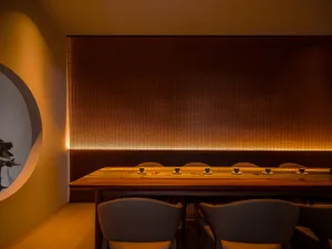 Modern restaurant interior with wooden elements and dim lighting