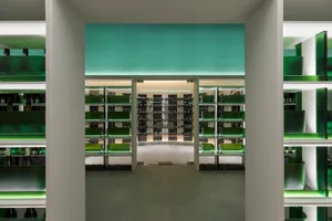 Modern interior design of a wine shop featuring glass-enclosed shelves.