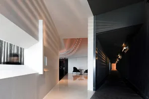 A modern restaurant interior with concrete floors and glass walls.