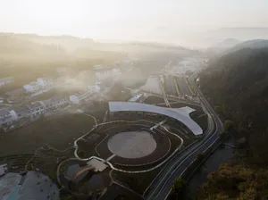 A modern cityscape with concrete highways winding through the landscape.