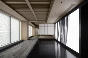 Modern interior design featuring a glass panel with abstract black and white image in a hotel lobby.