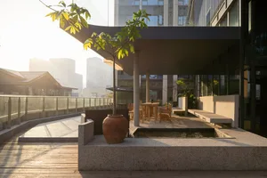 The modern urban outdoor lounge area with stone, concrete, and wood materials