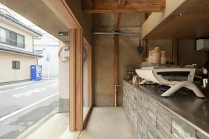 A minimalist storefront with a stone counter and coffee machine.