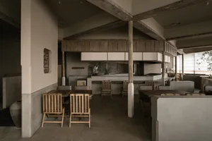 Industrial-themed restaurant interior with concrete finishes and minimalist design.