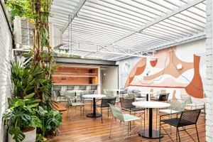 A modern cafe with metal, wood, and glass elements