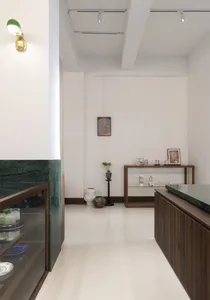 A modern lounge area with marble flooring and wooden furniture.