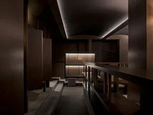 A modern restaurant interior featuring wooden elements and contemporary design.