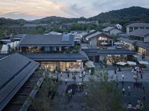 Aerial view of an urban shopping center with a mix of modern and traditional architectural styles, featuring ceramic tiles, w