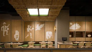 Interior shot of a restaurant with a bamboo ceiling, showcasing a dining area.