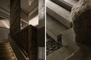 Modern staircase featuring wooden railings and concrete steps, within a contemporary interior space.