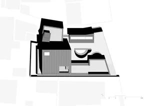 A modern concrete house with a glass courtyard and a partially submerged room.