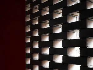 A modern interior space with a brick lattice wall.