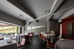 Modern, minimalist restaurant interior with neutral color palette and sleek, contemporary design elements.