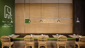 Cafe interior with bamboo, natural furniture, and metal accents