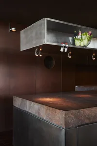 Modern minimalist kitchen with concrete countertops, featuring a sleek and contemporary design with clean lines and a monochr