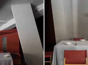 Modern restaurant interior with gray fabric walls and tables, showcasing contemporary design features.