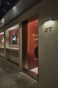 Modern building exterior featuring concrete and red materials