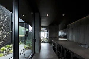 Modern commercial interior featuring minimalist design with concrete and glass materials.