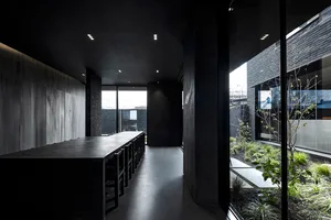 Interior of a modern, minimalist concrete house with a spacious open-plan living space.