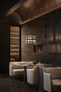 Industrial-style restaurant interior with brick walls and leather seating.