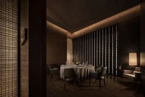A stylish modern restaurant interior with minimalist design elements and warm lighting.