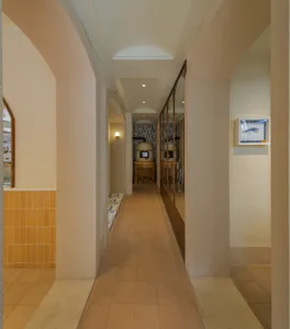 A corridor lined with tile walls and arches
