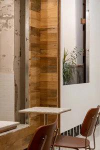 Modern industrial cafe interior with wooden walls and furniture