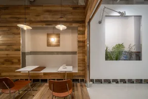 Industrial-style cafe interior featuring a wooden wall and table.