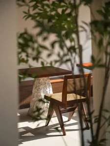 Coffee shop interior with wooden chairs and a rock table base