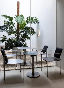 A modern cafe with metal furniture and plants