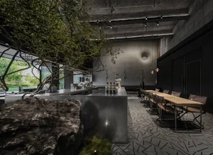 Industrial-style cafe interior with concrete features, showcasing modern design with a rustic touch.