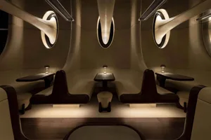Modern restaurant with white leather booths and dark wood accents