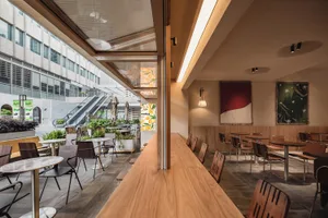 Modern cafe interior featuring wood and glass elements.