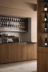 A modern coffee shop bar featuring a wooden interior design with wine bottles.