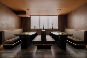 Industrial-style restaurant interior featuring concrete, wood, and metal materials.