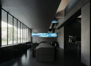 Interior view of a modern coffee shop featuring black furnishings and wooden surfaces.