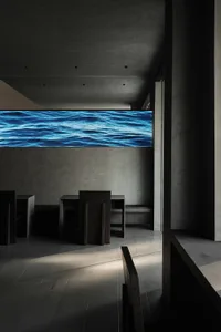 Interior view of a modern restaurant featuring a concrete floor wavy water display