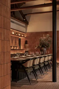 A modern restaurant interior featuring wooden furniture and decor.