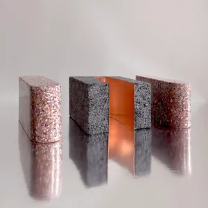 Modern architectural component made of concrete, featuring a minimalist design with geometric shapes and a reflective surface
